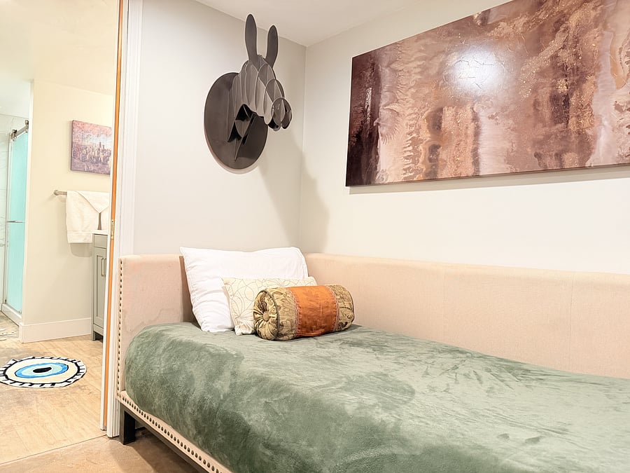 A spacious bedroom that doubles as a cozy mini living area, thoughtfully designed for both comfort and style. Enjoy a comfortable bed, modern seating, and warm lighting, creating the perfect space to unwind and feel right at home.