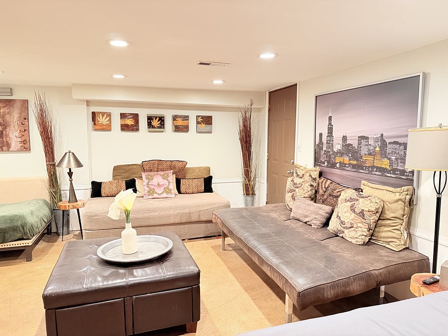 A spacious bedroom that doubles as a cozy mini living area, thoughtfully designed for both comfort and style. Enjoy a comfortable bed, modern seating, and warm lighting, creating the perfect space to unwind and feel right at home.