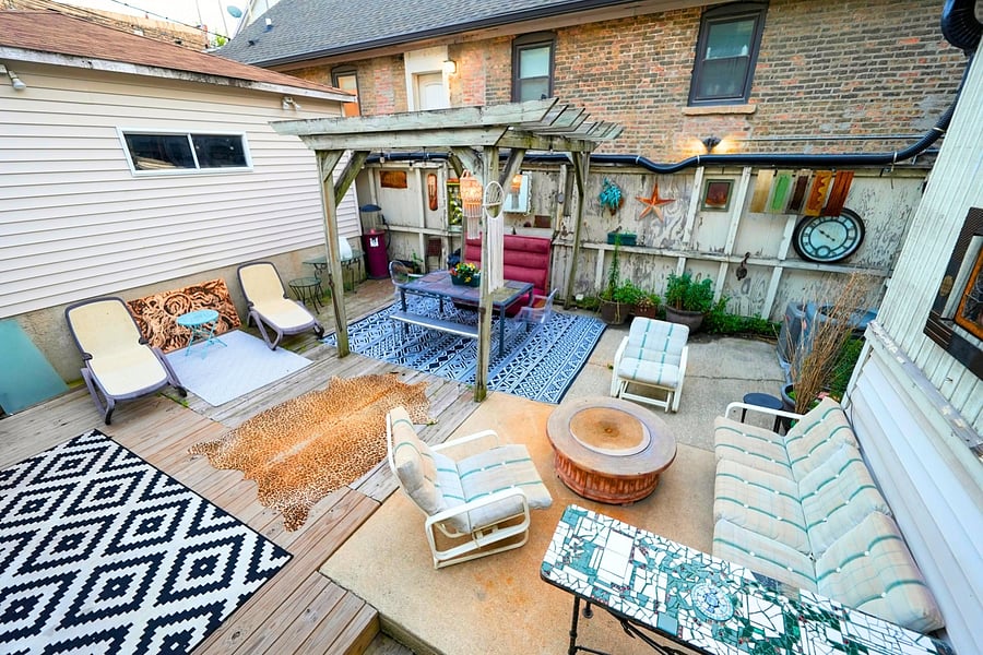 Shared backyard patio with lots of seating, perfect for relaxing and enjoying the serene outdoor atmosphere.