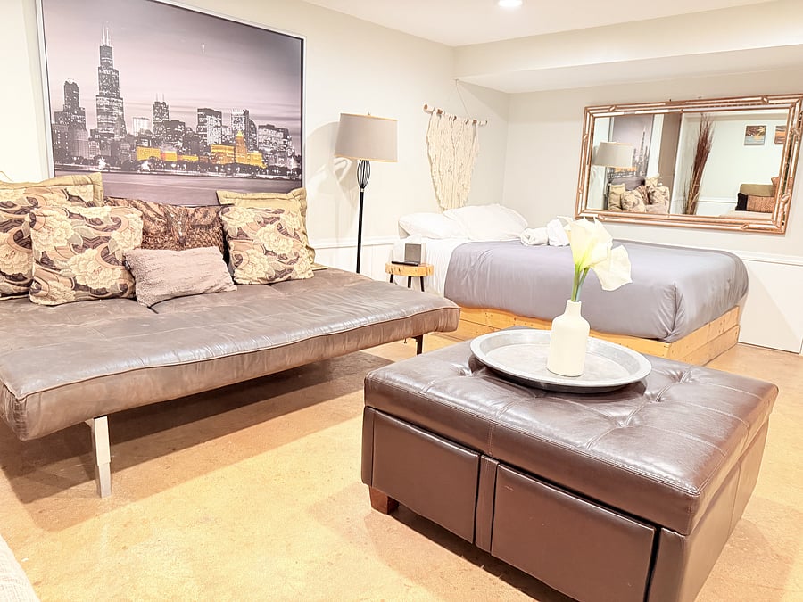 A spacious bedroom that doubles as a cozy mini living area, with a TV for your entertainment. Enjoy a comfortable bed, modern seating, and warm lighting, all thoughtfully arranged to create the perfect space to unwind, relax, and feel right at home.