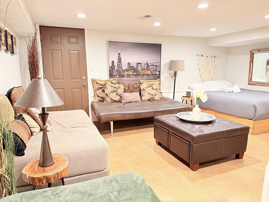 A spacious bedroom that doubles as a cozy mini living area, with a TV for your entertainment. Enjoy a comfortable bed, modern seating, and warm lighting, all thoughtfully arranged to create the perfect space to unwind, relax, and feel right at home.