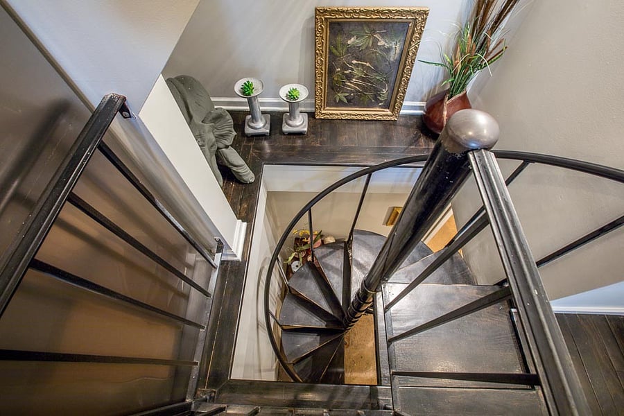 A spiral staircase leading you between levels with ease. Complemented by curated decor and warm finishes, this unique feature enhances the charm and personality of the space.