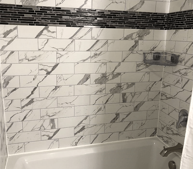 Fully remodeled bathroom with deep soaking tube and tiles up to the ceiling.