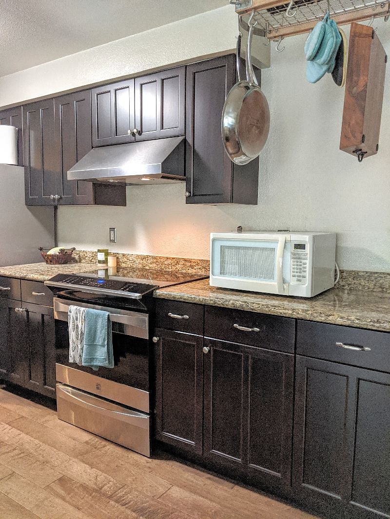 Kitchen with induction range, oven, full size refrigerator, and more. *Note, there is a toaster oven as well that is not pictured here.