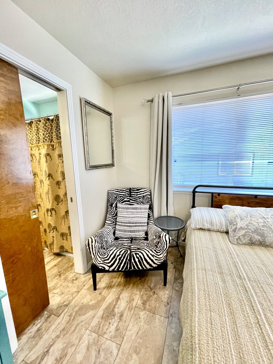 Bedside table and chair for reading with lots of natural sunlight.