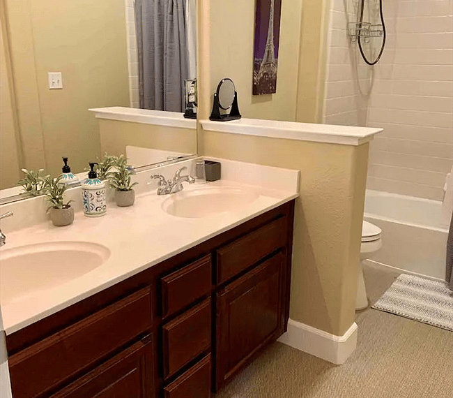 A shower and bath combo features in the bathroom