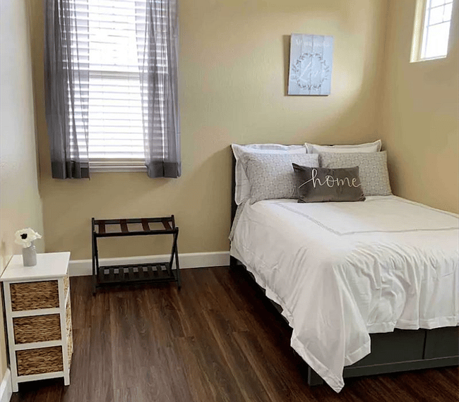 Grey bedroom with TV and walking closet