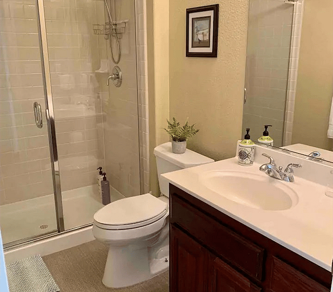 The bathroom is modern and stylish with shower, toilet and vanity