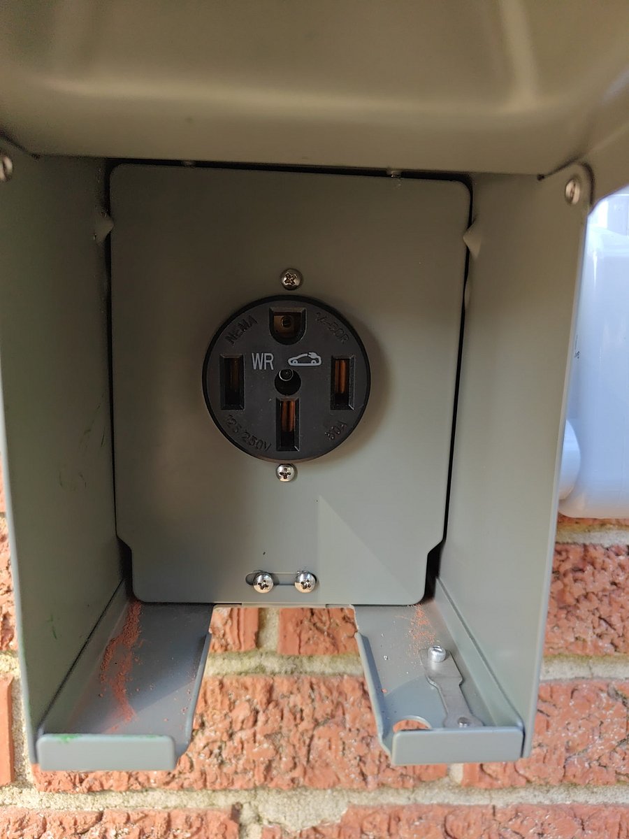 EV Charger located on brick retaining wall @ parking spots. 