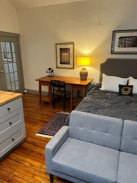 Full-size desk, french doors, leading out to hallway. 