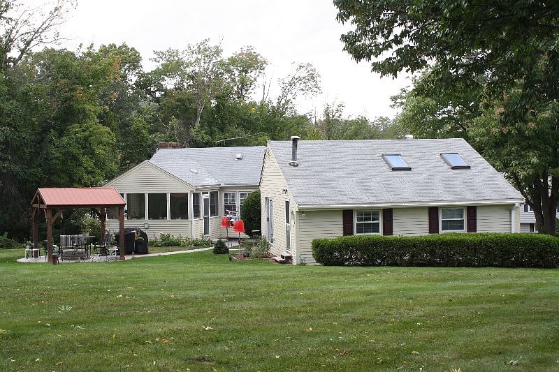Spacious back yard for outdoor activities. There's a fire pit under the gazebo.