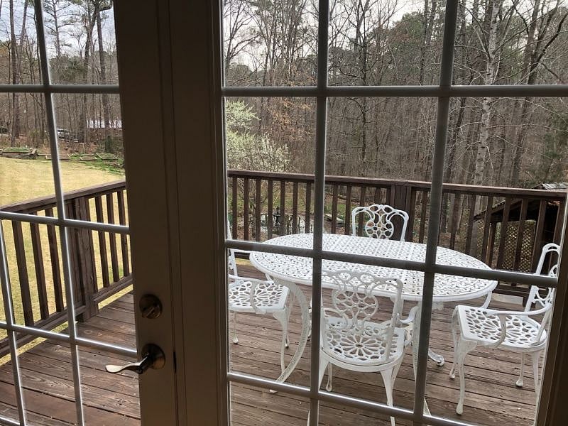 View out master bedroom to deck seating