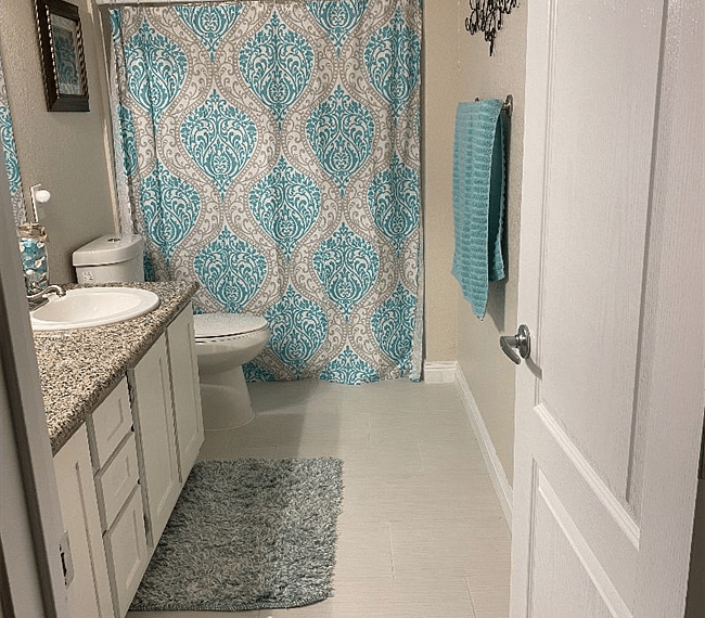 primary bathroom with double sinks & sunken tub