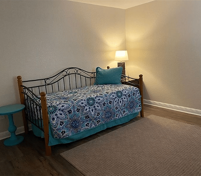 twin bed in guest room with a trundle underneath the bed offering additional sleeping 
