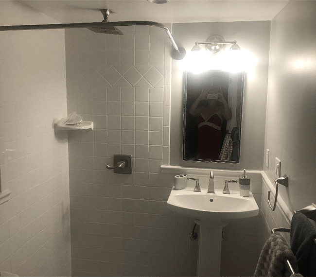 The bathroom is modern and stylish with shower, toilet and vanity