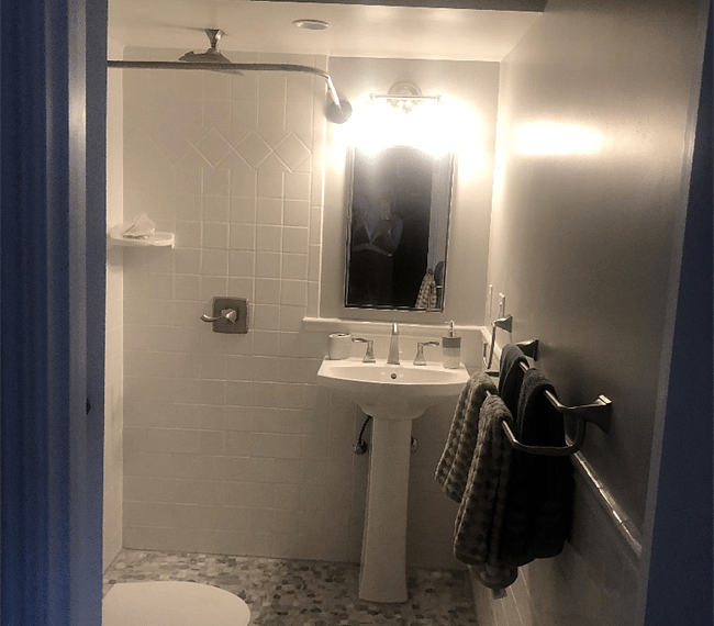 The bathroom is modern and stylish with shower, toilet and vanity