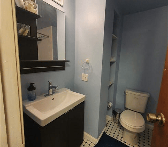 The bathroom is modern and stylish with shower, toilet and vanity