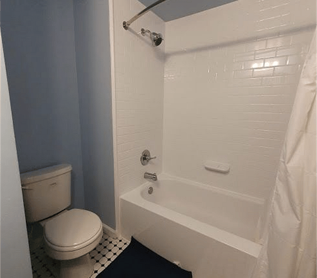 A shower and bath combo features in the bathroom