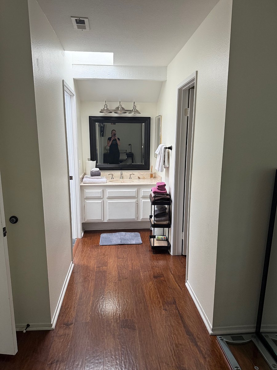 Master bedroom sink and walk-in closet to the right, full bathroom located to the left