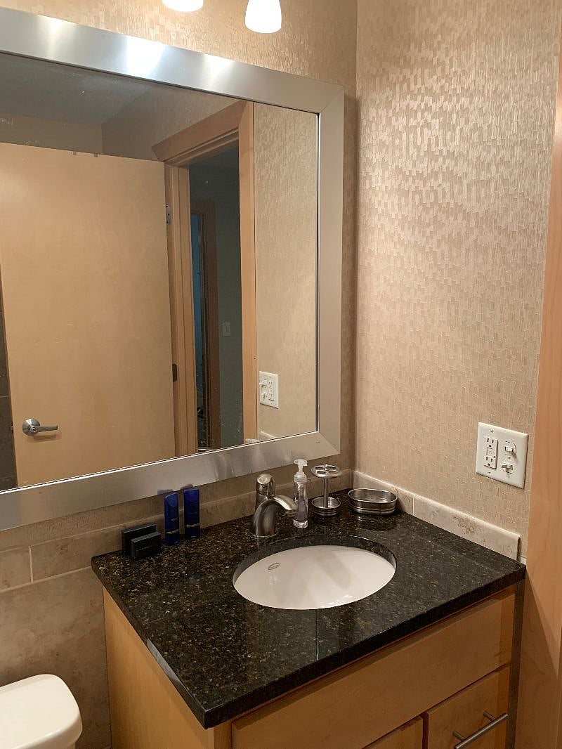 The bathroom is modern and stylish with shower, toilet and vanity