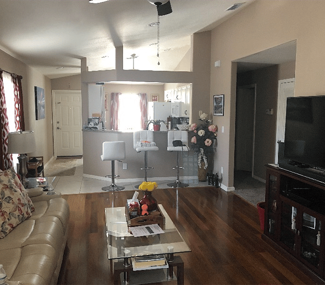 Looking Into area From the back of the living room, looking at the kitchen and the entrance/exit door on left. Down the hall on the right is your room and bathroom.