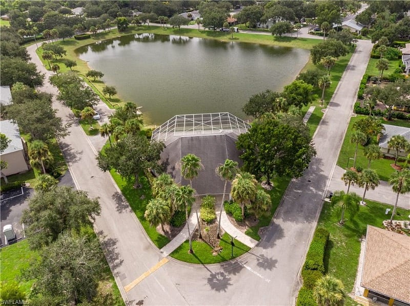An overhead aerial view of clubhouse from the backside. Screened in pool area just in front. The lake with fishing allowed for community only. Around a 1/4 of a mile walk around the lake.