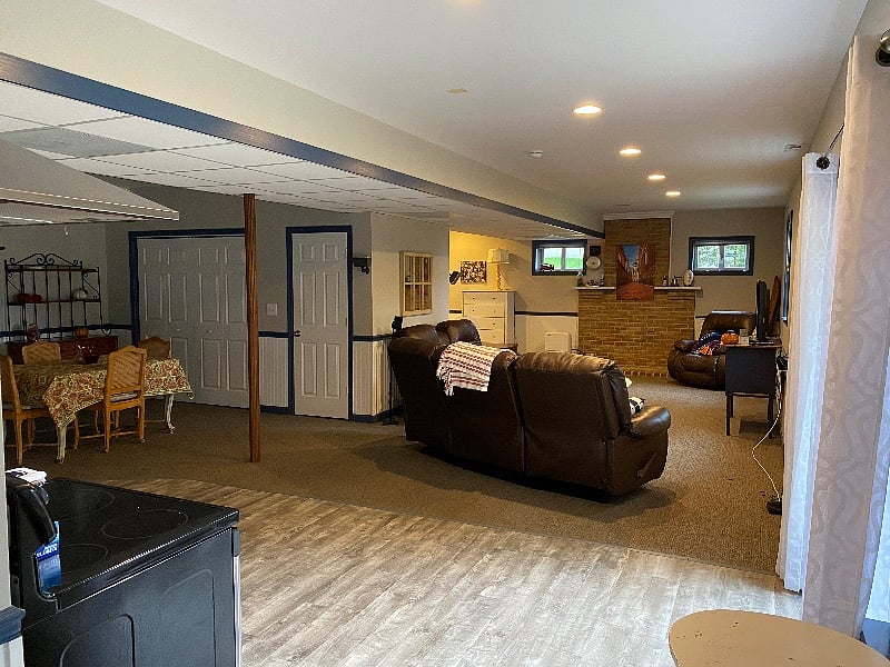 View from main entryway into kitchen and corner of dining room and living room with bedroom around the corner