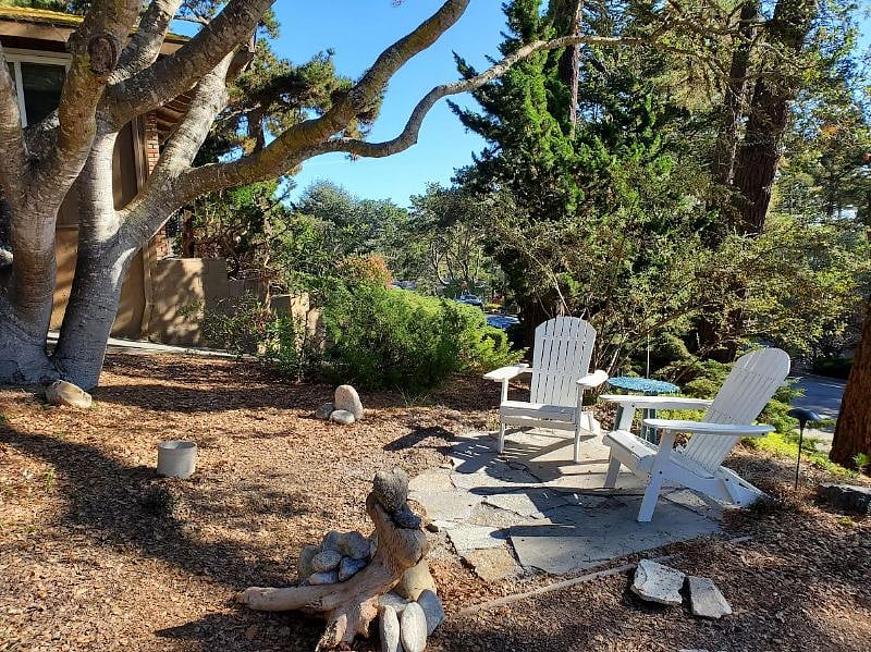 Private outdoor sitting area with Adirondack chairs.