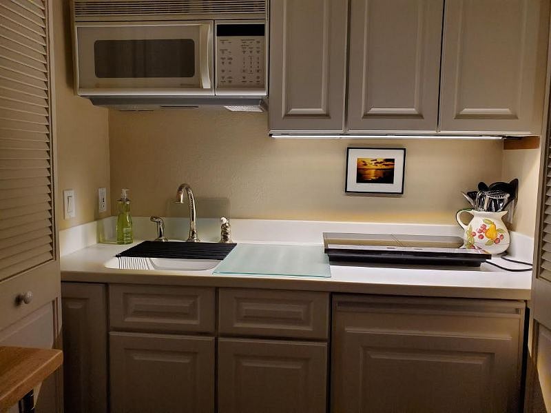 Kitchen showing fridge. Additional standard size fridge/freezer in adjacent area next to washerand dryer.