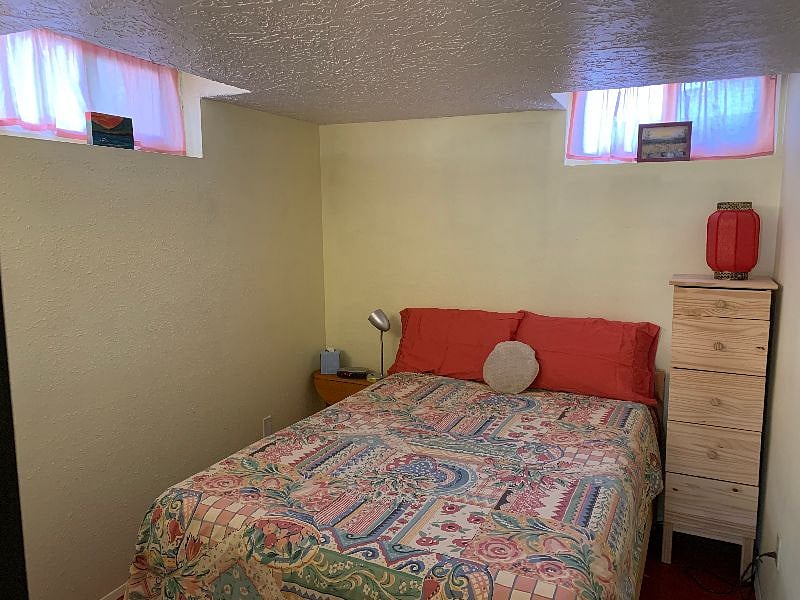 Full sized bed with a memory foam mattress toper for a comfy sleep.