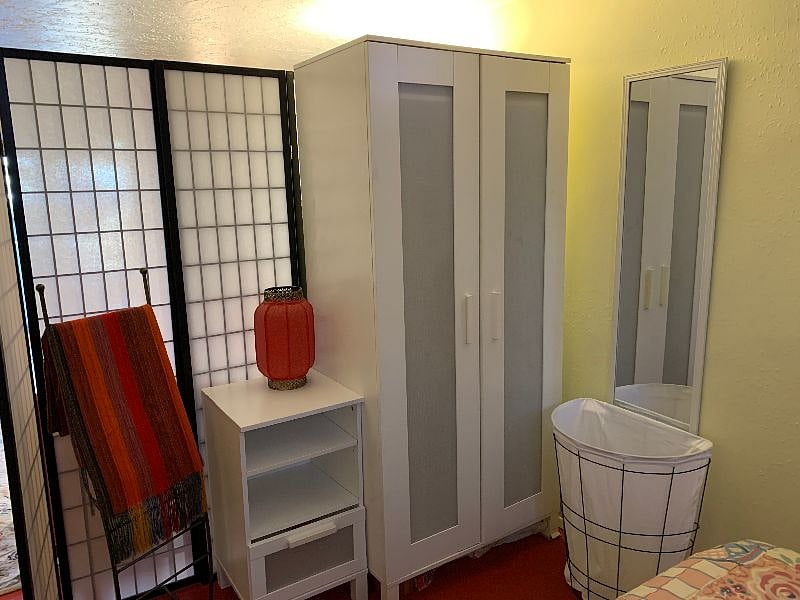 Wardrobe, and the small dresser is beside the bed.