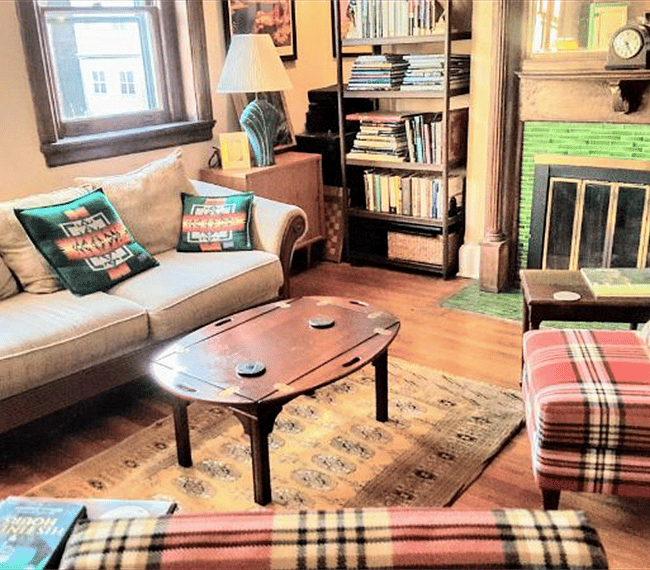 Sunlit living room, library & fireplace