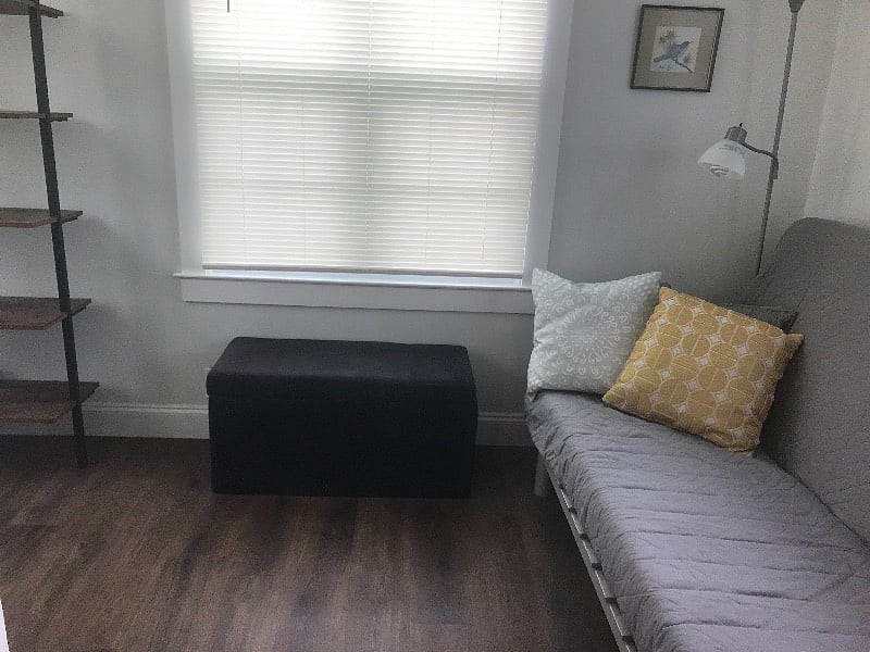 Small Office sunroom with futon and 2 large dog crates . Be careful not to scratch floor if you would like to use pull from behind futon. 