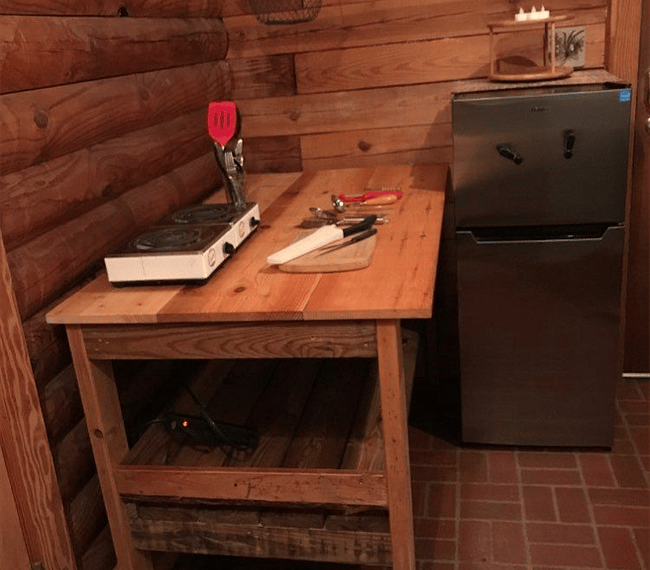 Cooking prep space and 4' refrigerator with freezer.
