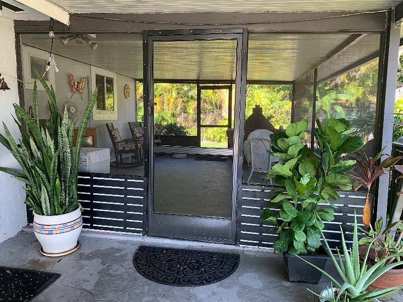 Screened porch with outdoor sink and brick barbecue