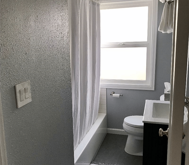 The bathroom features a tub and shower.
