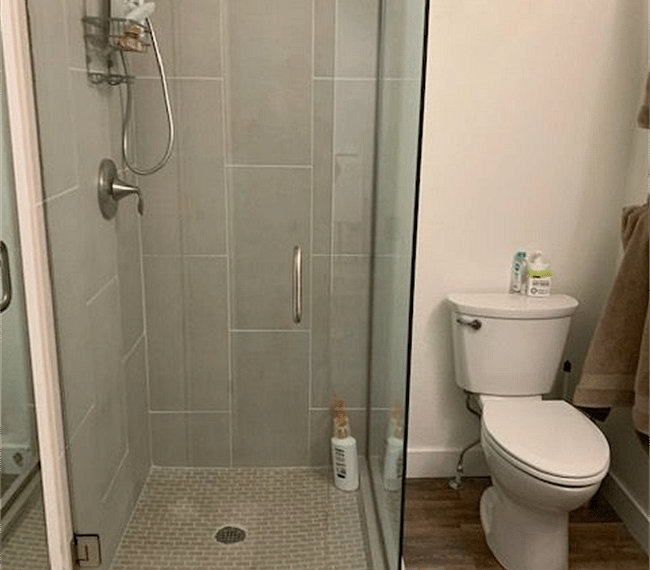 The bathroom is modern and stylish with shower, toilet and vanity