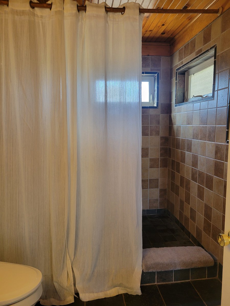 Looking toward walk in shower from bathroom entrance.