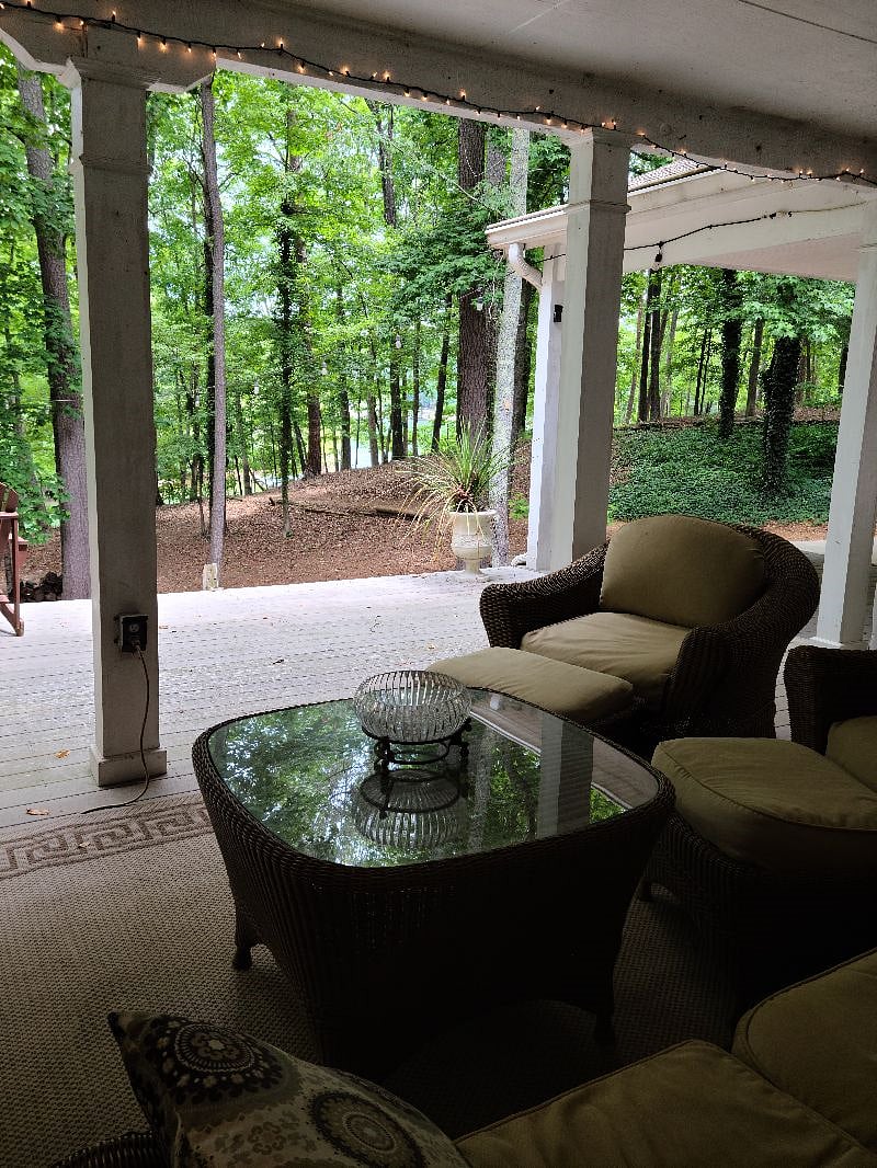 Comfortable, covered porch to sit and look at trees and lake.