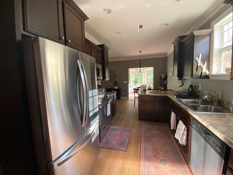 Kitchen with refrigerator, microwave, toaster, coffee maker, dishwasher, double sink with disposal, and basic cookware