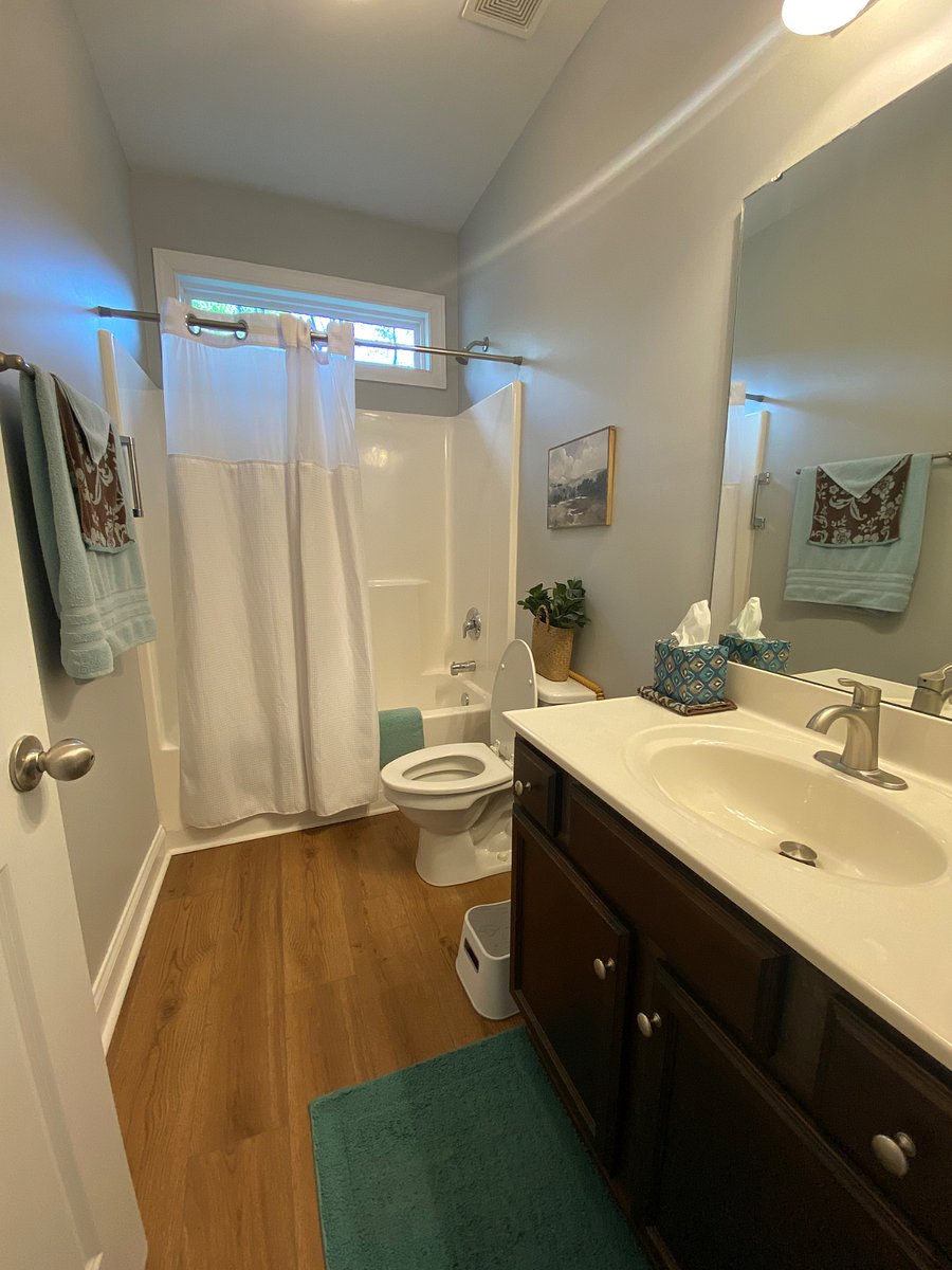 Hall Bathroom with tub/shower, single vanity and closet