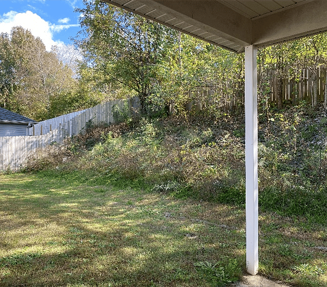Backyard is fenced. View is slightly different as this photo was before the porch was enclosed.
