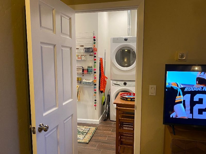 View from living area into kitchen/laundry/bath - separated spaces