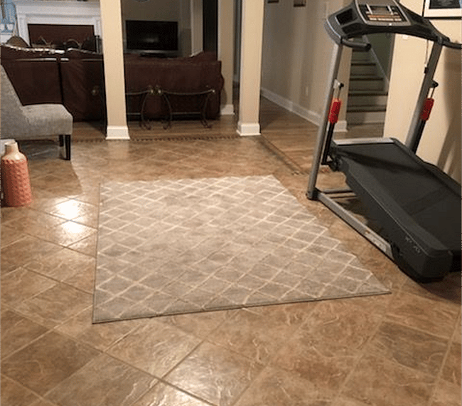 Open living and dining area with a treadmill