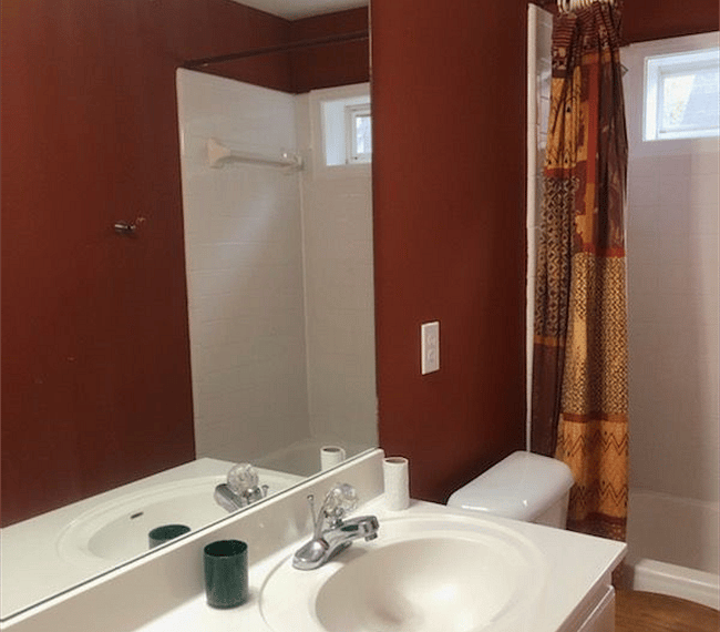 A shower and bath combo features in the bathroom 