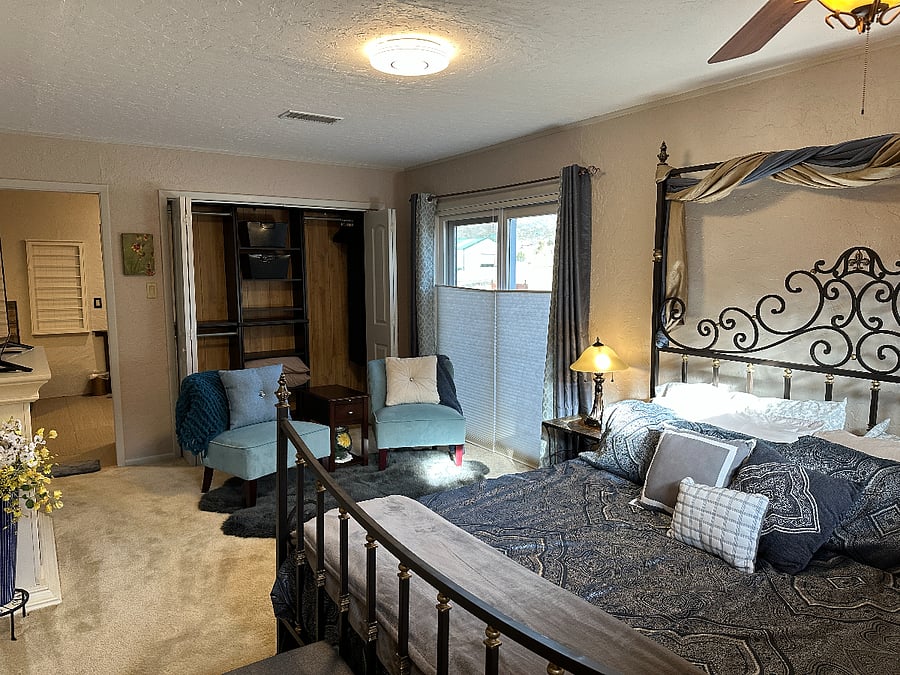Master bedroom with mountain view and sliding door to second floor deck