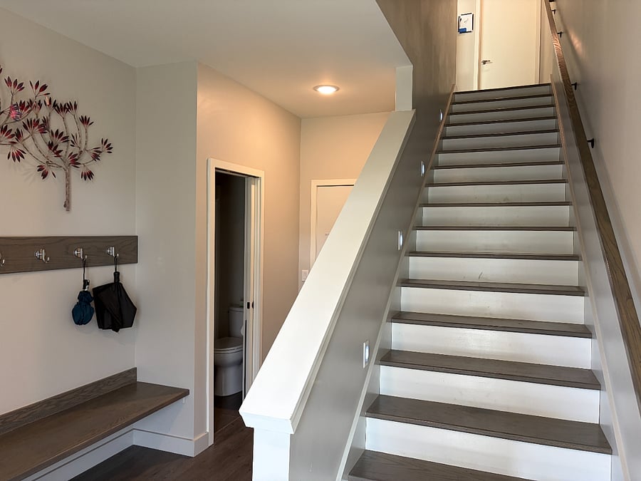 Stairs leading up to the shared kitchen and living room area. 