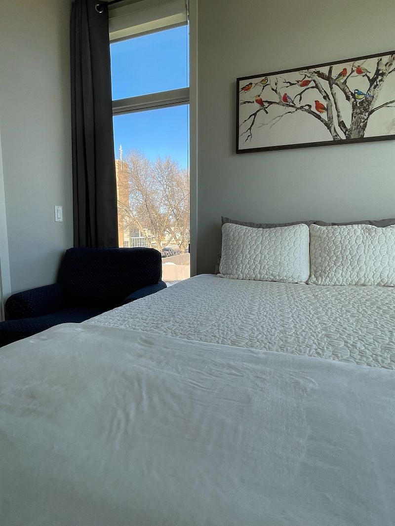 Queen size bed and extra seating.