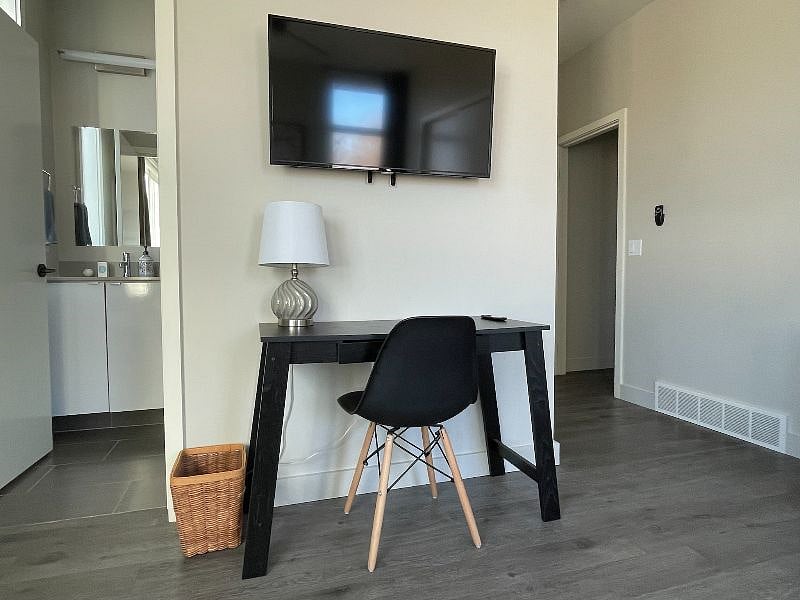 Smart TV and desk with chair.
