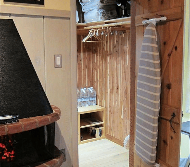 Walk-in closet, ironing board and extra linens